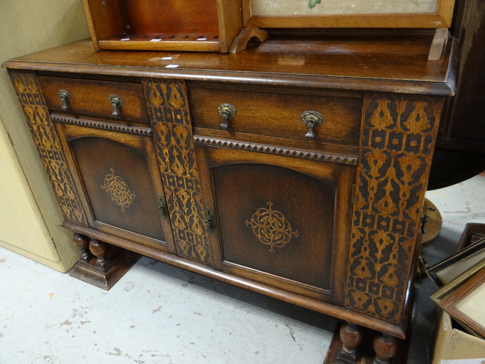 A vintage dark wood railback sideboard with decorative facade Condition reports provided on