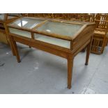 An Edmonds of Birmingham vintage museum display cabinet in table format with four hinging sloped