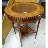 An Edwardian inlaid and painted circular top occasional table with shaped lower tier shelf on