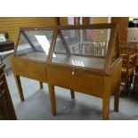 A vintage oak retailer's display cabinet with top section in glazed triangular format, the base with