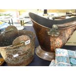 An oval based copper helmet coal scuttle with hammered body and swing handle and another Persian-