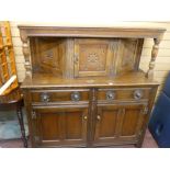 Polished buffet cupboard on turned supports and with carved upper panels