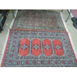 Two colourful antique style rugs, 150 x 92 cms and 160 x 95 cms