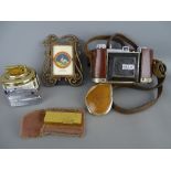 Leather cased Kodak vintage camera, four vintage lighters and a modern portrait frame containing a