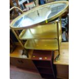 Brass effect three tier trolley, oval gilt framed bevelled edge mirror and two modern CD storage