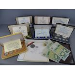 Seven boxed proof sets by Franklin Mint, eight vintage British one pound notes and a 2003 Coronation
