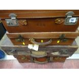 Four vintage leather and other suitcases
