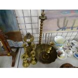 Brass oil lamp base, a selection of brass candlesticks and a bowl