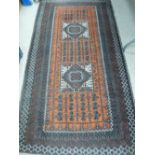 Rust coloured Eastern style rug, 210 x 114 cms