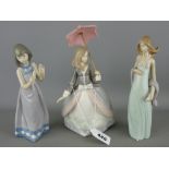 Three Lladro porcelain figurines of young girls, one with parasol