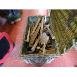 Wicker basket containing large quantity of hand tools including trowels, hammers, saws, files etc