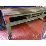 Substantial 8 x 3 ft approx workbench, no drawers on metal roller wheels, maker's name T Barker,