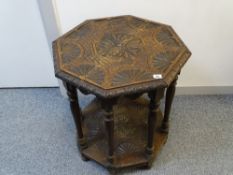 Octagonal carved top side table with base shelf
