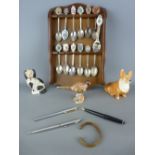 Quantity of collector's spoons on a wooden rack, a Sylvac corgi and a Staffs comforter dog, a gilt