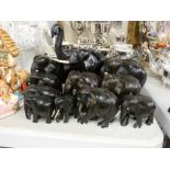 Two sets of carved ebony graduated elephant ornaments