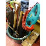 Large plastic garden bucket with contents of long handled garden tools, spirit level and manual saw,