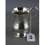 Small silver tankard of waisted form on a pedestal foot with floral chased monogrammed cartouche,