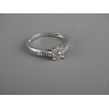 Nine carat white gold ring with diamond set shoulders and cluster setting