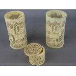 Two early 20th century reticulated ivory sleeve vases and a carved lidded box