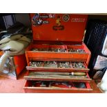 Red three drawer toolbox containing various hammers, files, screwdrivers and sockets