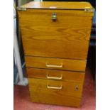 Small office filing cupboard with base drawers and upper filing section with brass bound corners