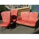 Vintage Ercol three piece suite comprising two seater settee and a pair of highback armchairs