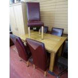 Fine modern oak effect extending dining table and a set of six leather effect dining chairs