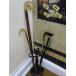 Black painted cast stickstand with a quantity of sticks