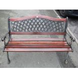 Garden bench with lattice pierced back and metal cast ends and wooden slats