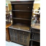 A Priory or type linen-fold narrow dresser with a base of two cupboards and two drawers, 88cms