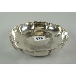 An Irish silver dish formed with border of eight lobes with ogee rims and with engraved Celtic