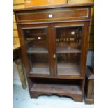A vintage painted mahogany two-door glazed bookcase with lower open shelf Condition reports provided