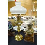 A brass based and reservoir oil lamp together with a boxed drawer base oil lamp Condition reports