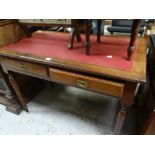 A small mahogany two-drawer writing desk on fluted supports and with red leather insert top,