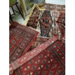 A Persian wool carpet with intricate rust, cobalt blue and brown woven decoration, 210cms wide and