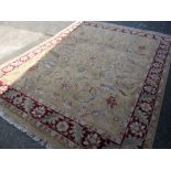 Good quality gold floral and red bordered woollen rug with fringe ends, 244 x 305cms Condition