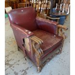 A turn-of-the-century carved club-type chair in buttoned red leather (for repair / re-upholstery)