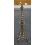 A vintage brass tripod floor standing oil lamp base, 125cms high