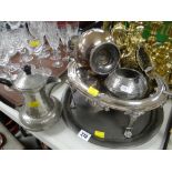 An Edwardian EPNS visor-type revolving tureen and a beaten pewter tray, jug and sugar basin, pair of