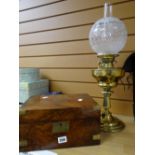 An antique brass oil lamp and a nineteenth century mahogany writing box Condition reports provided