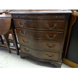 An antique reproduction serpentine chest of four long drawers and with upper brush-slide, 70cms wide