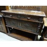 A nineteenth century carved oak buffet sideboard on barley-twist supports, with a base of two