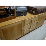 A modern light oak sideboard with three drawers flanked by cupboards Condition reports provided on