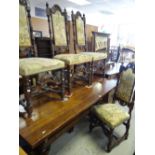 A twentieth century oak refectory-style dining table, 183cms long and six carved tapestry seat and