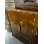 A vintage polished cocktail cabinet with period interior wallpaper and glass interior, 98cms high