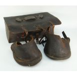 A pair of antique leather horse boots / hoof boots / lawn boots with straps and buckles together