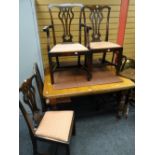 An extending wind out mahogany Edwardian dining table with two leaves and 4+1 Chippendale-type