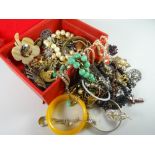 A red jewellery box and mixed costume jewellery contents Condition reports provided on request by