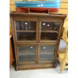 A vintage two-section glazed and oak library bookcase Condition reports provided on request by email