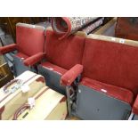 A trio of adjoining vintage numbered red-velvet covered and grey metal folding cinema-seats